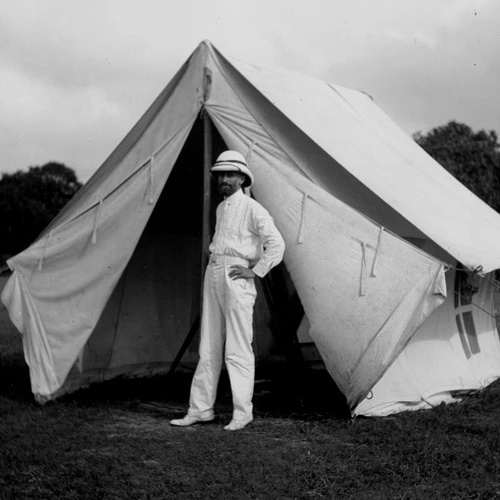 Carnegie investigator Louis Bauer stands outside a tent during field work pertaining to terrestrial magnetism in Colombo, Ceylon.
