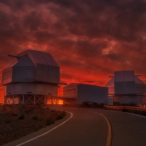 Sunset reddens the sky behind the Magellan telescopes at Carnegie's Las Campanas Observatory in Chile.