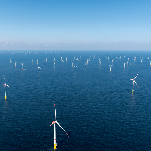 Offshore wind farm in blue water. 